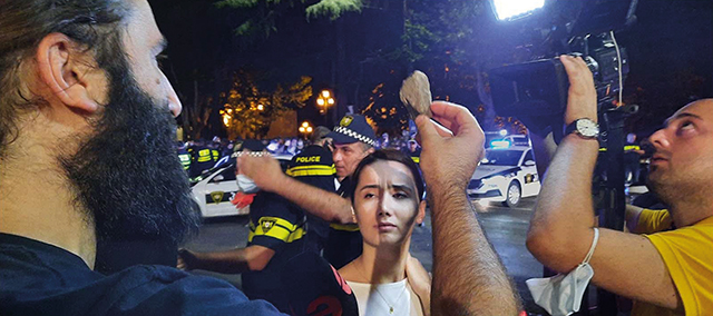 Pride protester displaying a rock that was allegedly thrown at him. Photo by Mike Godwin