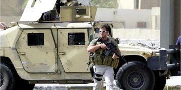 PMC company employees secure the site after a roadside bomb in Baghdad, Iraq, in September, 2007. Photo by Ahmad Al-Rubaye/ AFP
