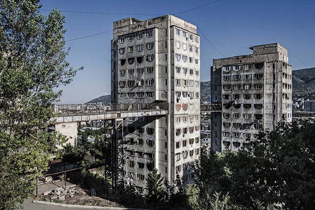 An interconnected pair of Brezhnevka-style apartment buildings in Tbilisi, constructed in 1976 and showing the panels of concrete common in mid-century Soviet architecture. Photo by Roberto Conte