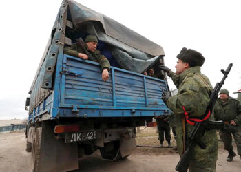 Pro-Russian troops in the separatist-controlled settlement of Mykolaivka, Ukraine, on March 1, 2022. Photo by Alexander Ermochenko/Reuters
