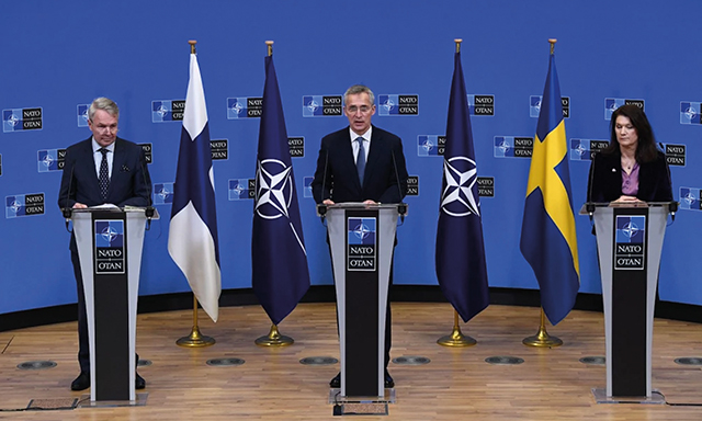 NATO Secretary-General Jens Stoltenberg, Finnish Foreign Minister Pekka Haavisto, and Swedish Foreign Minister Ann Linde speak at a press conference after their meeting at NATO headquarters in Brussels on Jan. 24. By John Thys/AFP via GETTY IMAGES