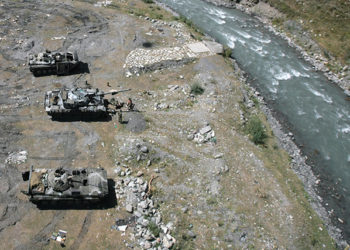 Russian army trucks on a riverbank in Nar, near the border between Russia and Georgia, on Aug. 15, 2008. By Natalia Kolesnikova/AFP via Getty Images