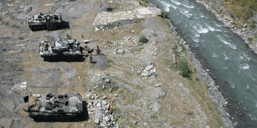 Russian army trucks on a riverbank in Nar, near the border between Russia and Georgia, on Aug. 15, 2008. By Natalia Kolesnikova/AFP via Getty Images