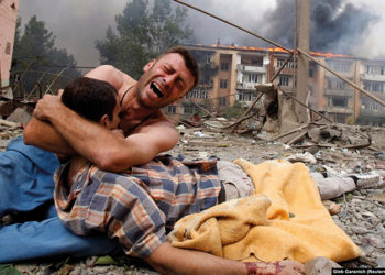 A Georgian man cries as he holds the body of a loved one after a Russian bombardment on August 9, 2008, in Gori, Georgia, near the border of the breakaway region of South Ossetia. Photo by Gleb Garanich (Reuters)