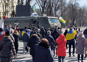Demonstrators chant "go home" while walking towards retreating Russian military vehicles in Kherson, Ukraine March 20, 2022. Source: REUTERS