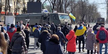 Demonstrators chant "go home" while walking towards retreating Russian military vehicles in Kherson, Ukraine March 20, 2022. Source: REUTERS