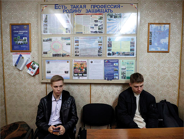 Young Russian men sit in line at a military recruitment office in Novosibirsk. Source: ITAR-TASS/Kirill Kukhmar