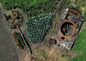 A destroyed Russian tank is seen in a backyard garden of a local resident Valerii in the village of Velyka Dymerka, Kyiv region, Ukraine. Photo by Valentyn Ogirenko/REUTERS