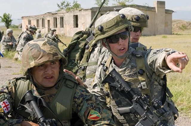Georgian and US servicemen during a military training exercise outside Tbilisi, Georgia, prior to the 2008 war. Photo by Cliff Patrick / AP 
