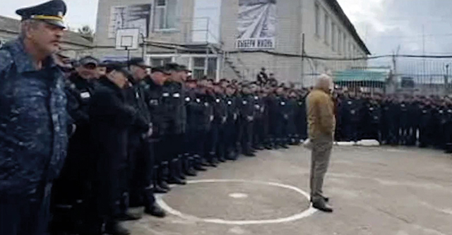 A still from the video showing Yevgeny Prigozhin, center in tan, recruiting prisoners to take part in the fighting in Ukraine. Unknown source via RFL