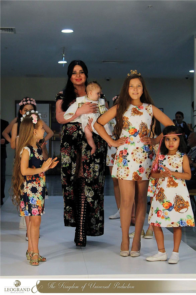 Maya works with youth models prior to a showing of her women’s and children’s designs. Photo courtesy of Maya Tavadze