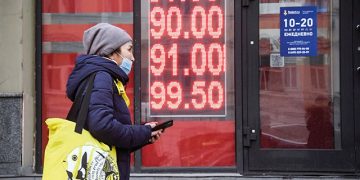 A woman walks past a currency exchange office in central Moscow on Feb. 24. Photo by Alexander Nemenov/AFP via Getty Images