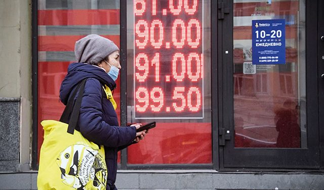 A woman walks past a currency exchange office in central Moscow on Feb. 24. Photo by Alexander Nemenov/AFP via Getty Images