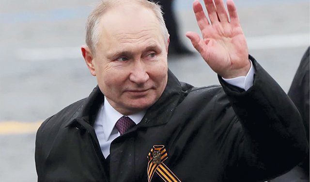 Russian President Vladimir Putin waves while walking along Red Square. Photo by Evgenia Novozhenina/Reuters