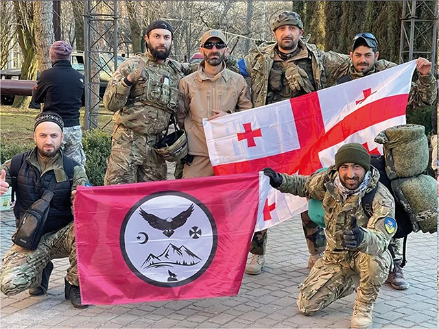 Pro-Ukrainian volunteers pose with the Georgian national flag and the Caucasus Legion battle flag. Source: Telegram