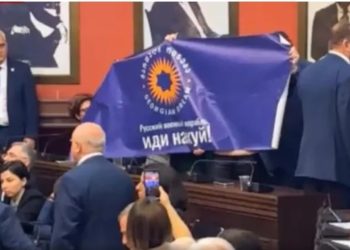 Opposition MPs unfurl poster with inscription “Русский военный корпаль иди на…”