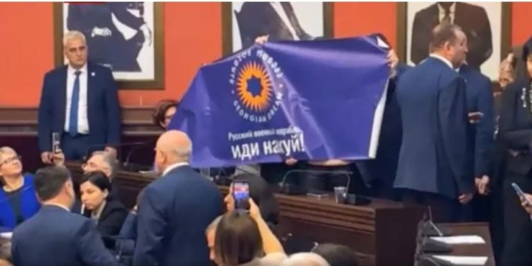Opposition MPs unfurl poster with inscription “Русский военный корпаль иди на…”
