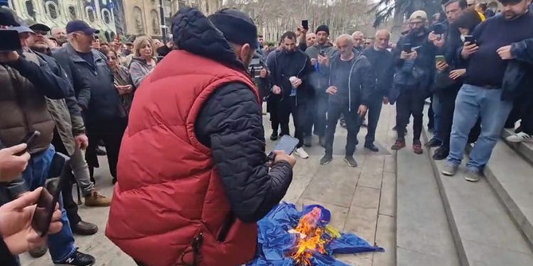 Alt-Info and Conservative Movement group members burn the EU flag. Photo from Telegram