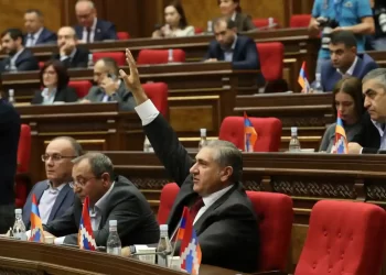 Armenian lawmakers voting in Yerevan on Tuesday to join the international criminal court. Picture from The Guardian, Photograph: Hayk Baghdasaryan/AP