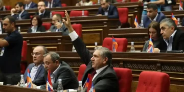 Armenian lawmakers voting in Yerevan on Tuesday to join the international criminal court. Picture from The Guardian, Photograph: Hayk Baghdasaryan/AP