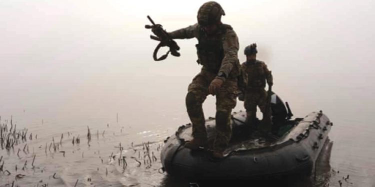 A Ukrainian serviceman goes ashore at the frontline near Kherson, amid Ukraine’s war with Russia. Photograph: Alex Babenko/AP