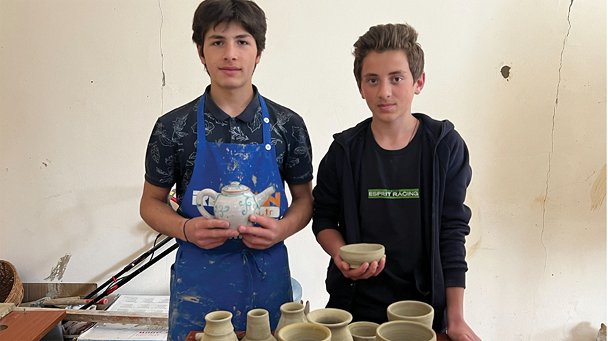 Apprentice potter Gio and friend at Nikozi's children's arts education center