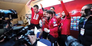 Georgia's players celebrate after beating Greece on penalties in the playoff final. Giorgi Arjevanidze/AFP/Getty Images