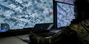 A Ukrainian soldier watches a drone feed from an underground command center in Bakhmut. Source: Libkos/AP Photo