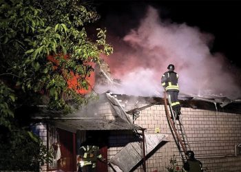 Firefighters work at a site of a residential building damaged during a Russian drone strike. Source: Reuters