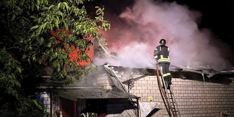 Firefighters work at a site of a residential building damaged during a Russian drone strike. Source: Reuters