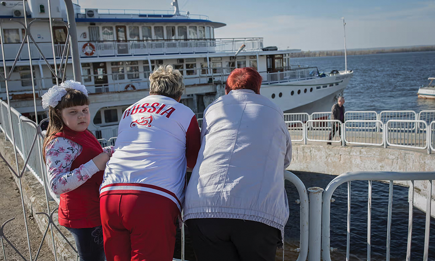 Russian tourists look at a cruise ship. Photo by Dmitiri Beliakov for The Guardian