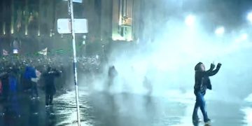 Riot police hit protesters and media with water jets