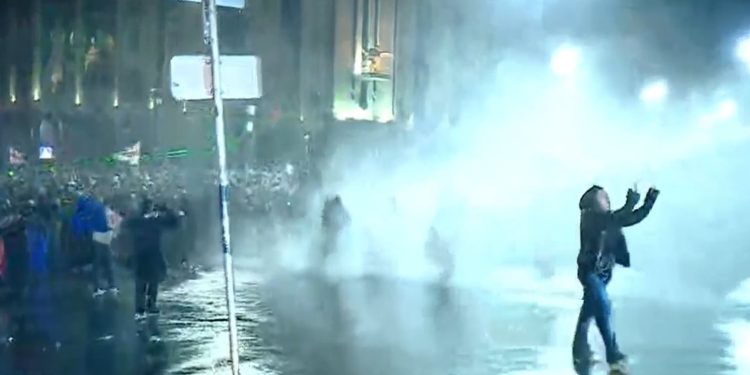 Riot police hit protesters and media with water jets