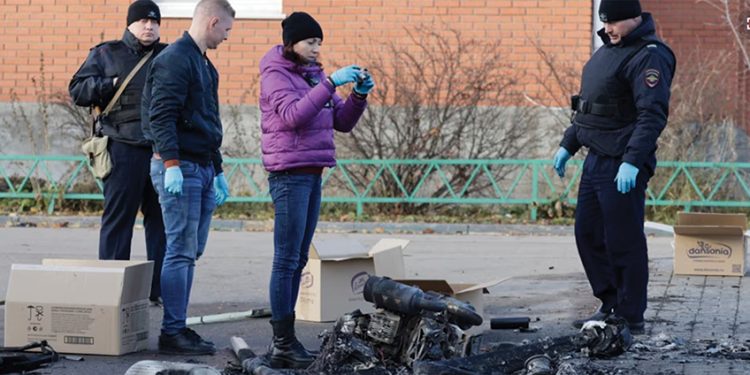 Russian law enforcement officers inspect the wreckage of a drone following an attack in a village in the Moscow region on November 10. Source: AFP