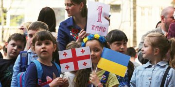 Children line up for their first day at Tbilisi’s new Ukrainian school in 2022. Photo by Giorgi Lomsadze for Eurasianet.