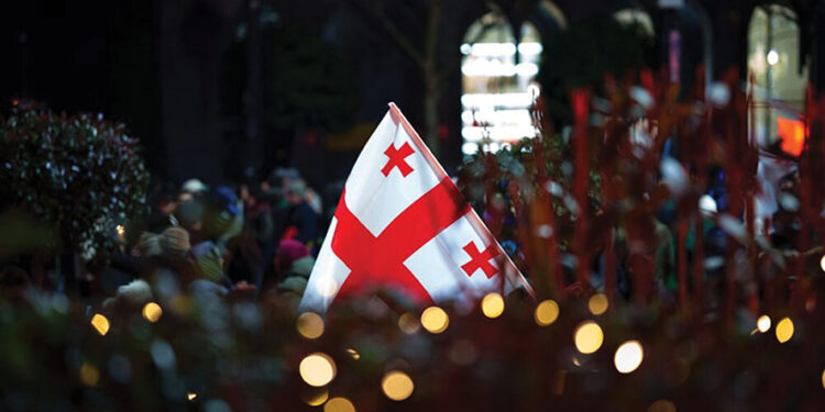 The Georgian flag at a peaceful protest. Image source: Reuters