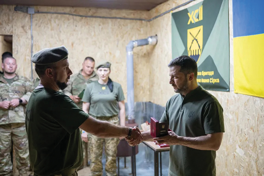 Ukraine's President Volodymyr Zelenskyy presents a medal to a Ukrainian serviceman of the 92nd Separate Assault Brigade at an undisclosed location in the Kharkiv region, on August 4. Source: Handout/Ukrainian Presidential Press Service/AFP