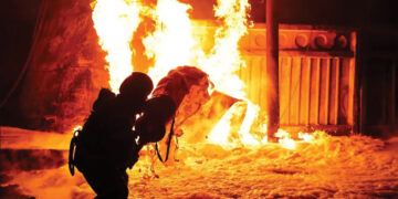 A firefighter works at the site where a critical infrastructure facility was hit by Russian drone strikes in Ukraine. Source: Reuters