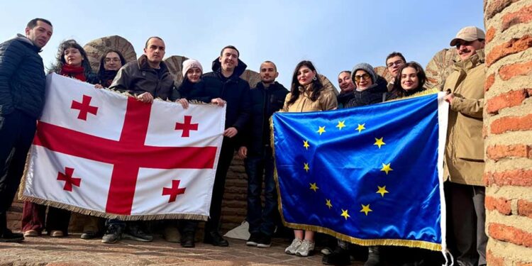 Youth groups display Georgian and EU flags at Narikala for State Flag Day