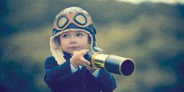 A child with a telescope. Source mind24-7