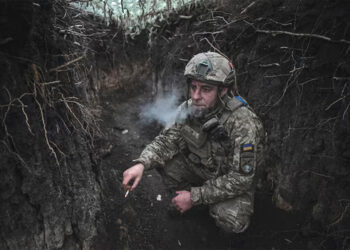 An artilleryman of Ukraine's 44th Separate Artillery Brigade smokes in a trench in Dnipropetrovsk region, Ukraine. Source: REUTERS/Stringer