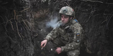 An artilleryman of Ukraine's 44th Separate Artillery Brigade smokes in a trench in Dnipropetrovsk region, Ukraine. Source: REUTERS/Stringer