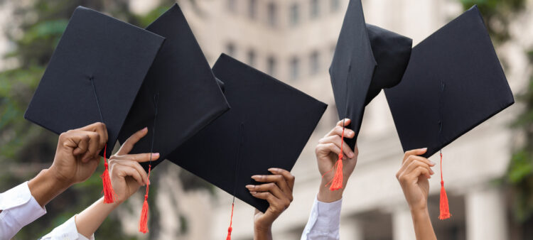 Students holding graduate hats. Photo: Public Policy Institute of California.
