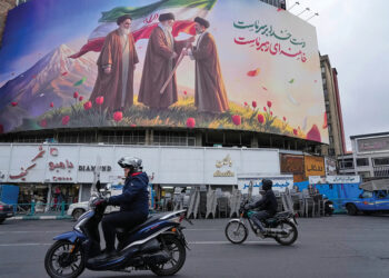 A billboard depicting Iran’s late Supreme Leader Ayatollah Ali Khamenei handing the country’s flag to his son and successor Ayatollah Mojtaba Khamenei. Source: AP Photo/Vahid Salemi