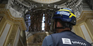 A UNESCO inspector checking damage in Ukraine. Source: UNESCO