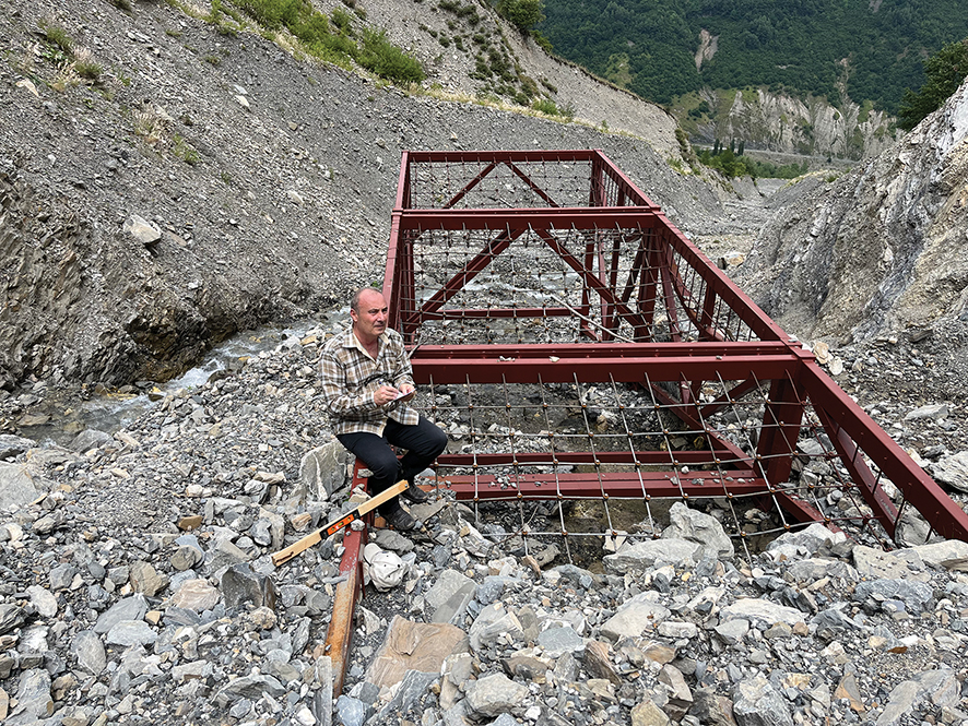Debris-flow mass retained by the flexible debris-flow barrier in the Mleta River gorge.