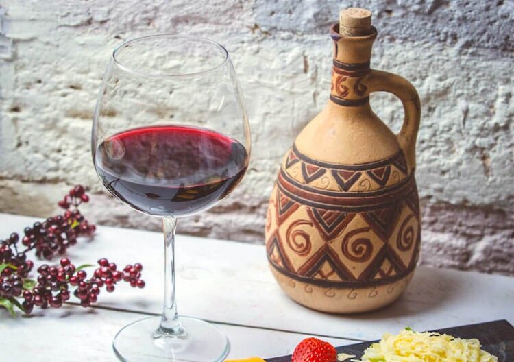 Glass of wine and traditional Georgian jug.