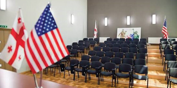 Georgian and US flags in a university auditorium. Source: Education in Georgia