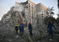 Rescuers extinguish a fire in a damaged residential building following Russian missile and drone strikes. By Genya Savilova/AFP/Getty Images