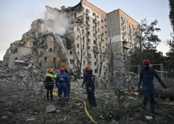 Rescuers extinguish a fire in a damaged residential building following Russian missile and drone strikes. By Genya Savilova/AFP/Getty Images